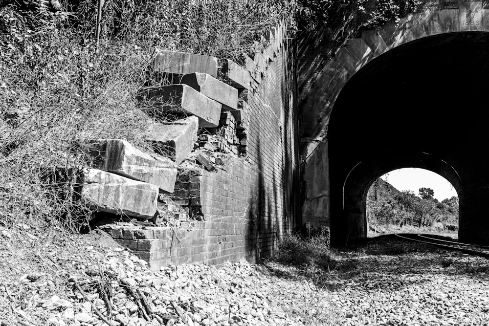 a stone tunnel with a bench