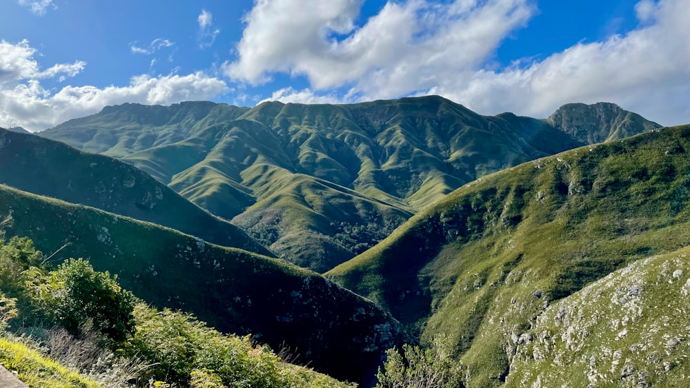 a valley with mountains in the background