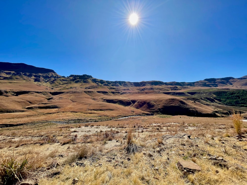 a desert landscape with a bright sun