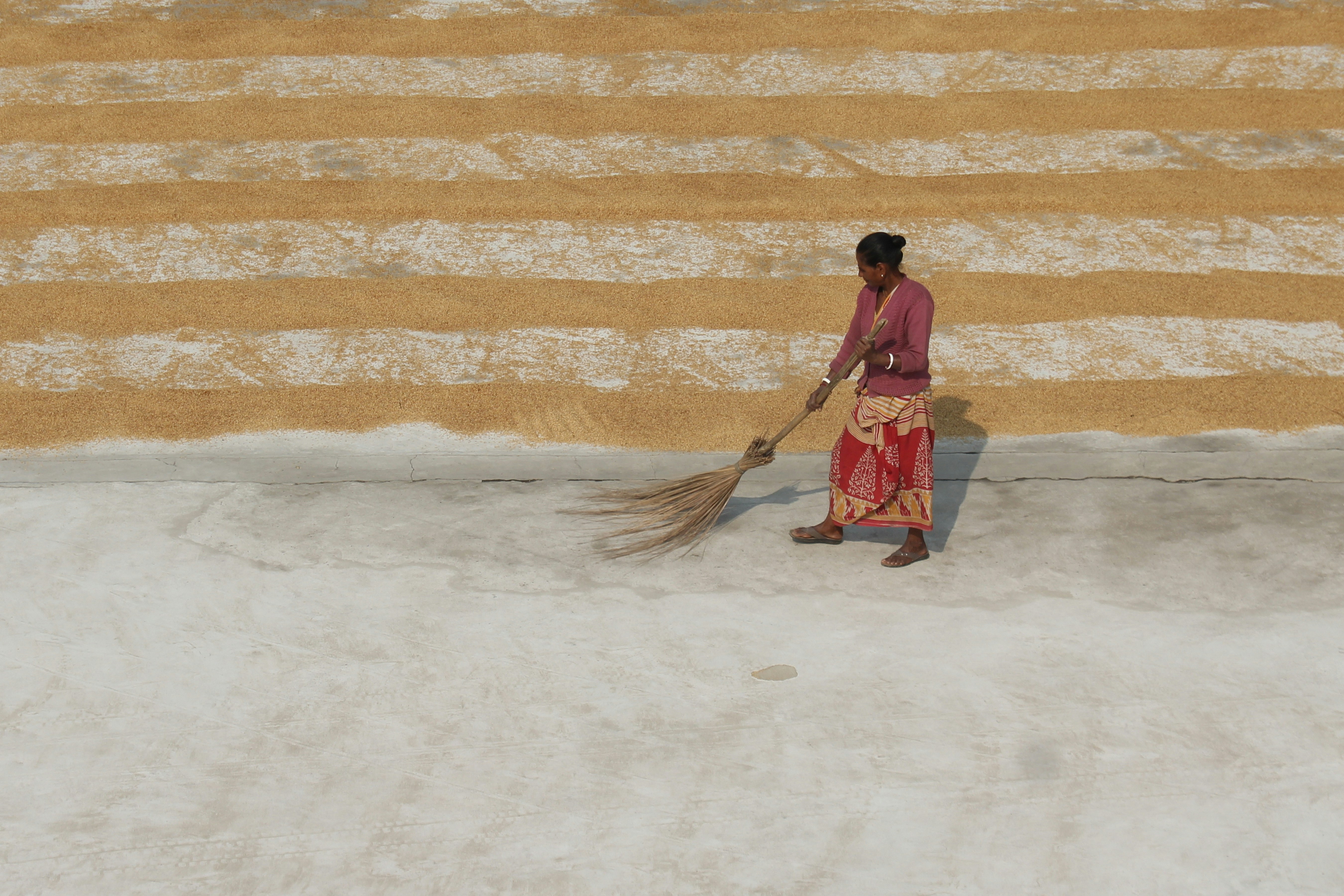 a man carrying a broom