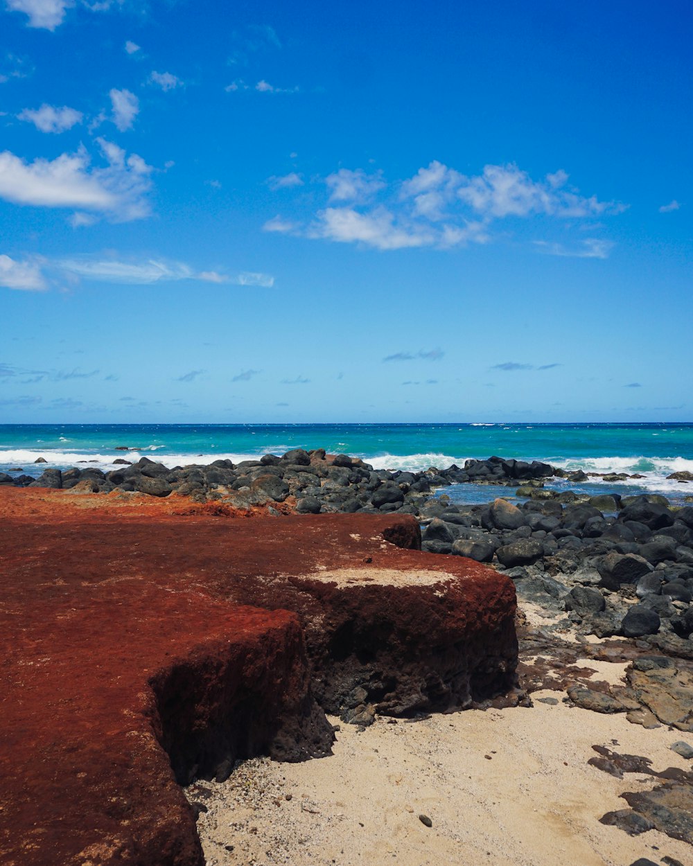 a rocky beach with waves crashing