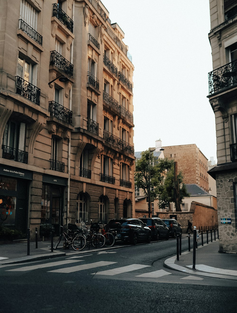 a street with cars and bicycles parked on the side