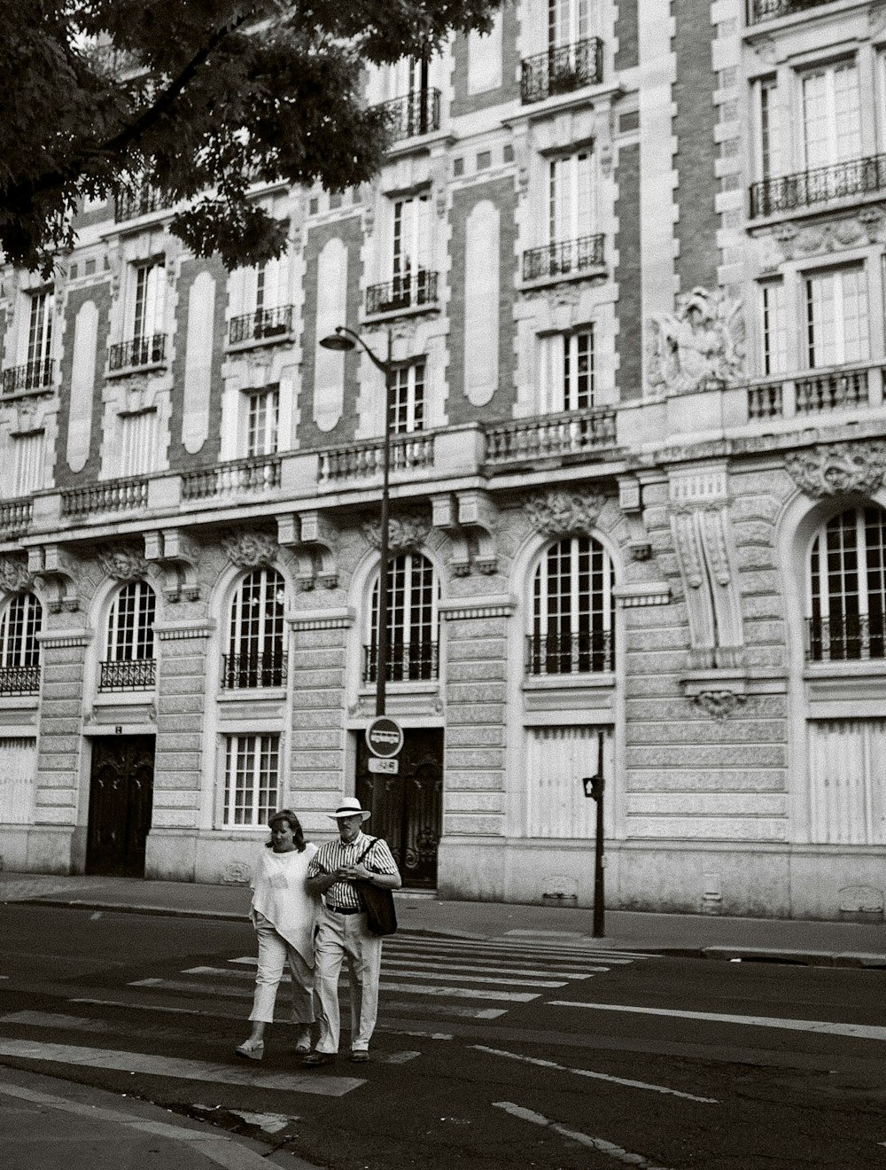 a couple of men standing in front of a building