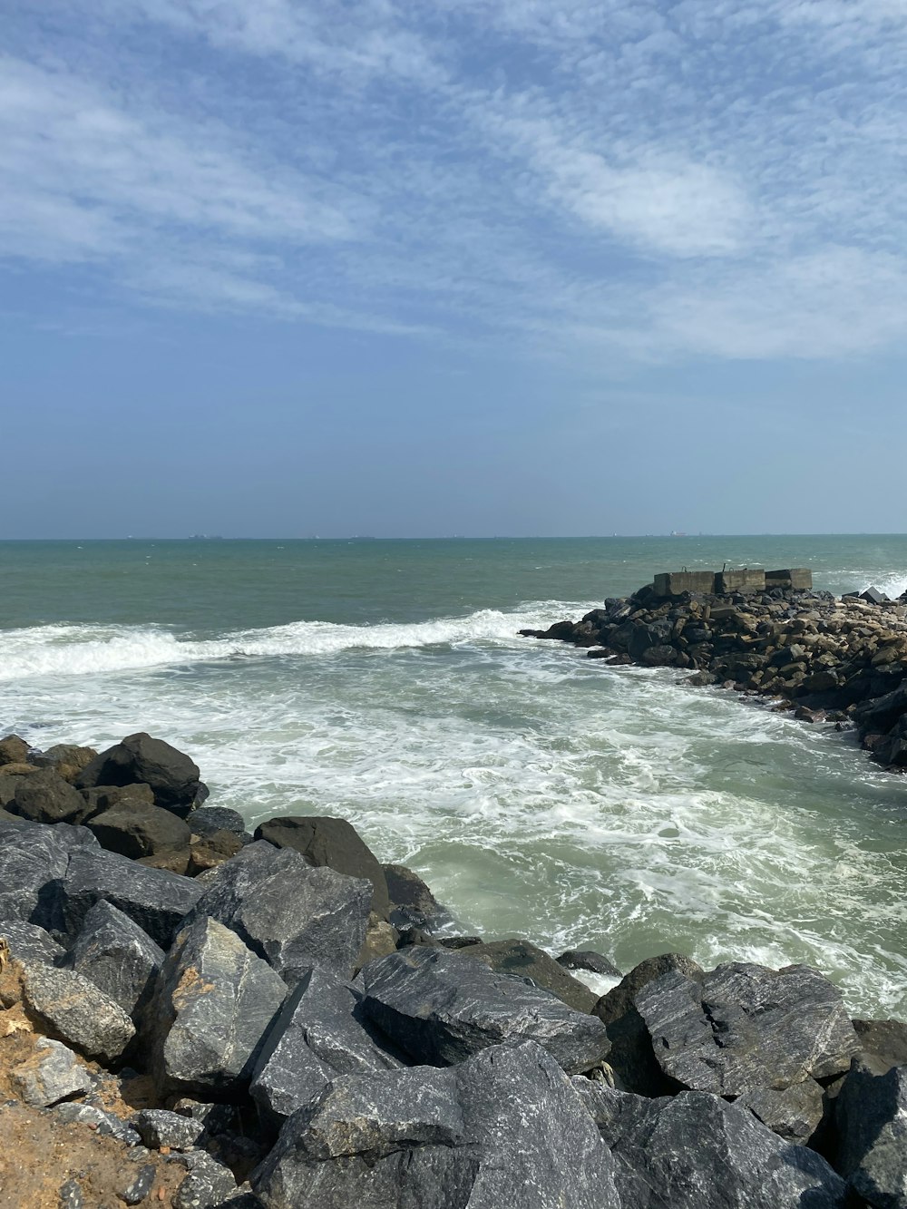 a rocky beach with waves crashing