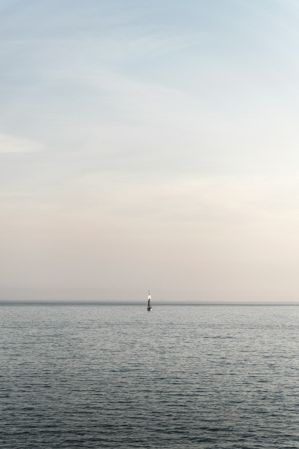 a sailboat in the middle of the ocean