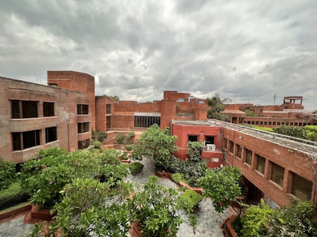 a building with trees and plants in front of it
