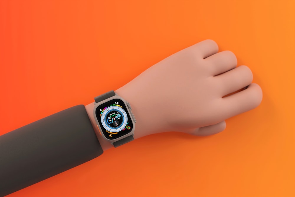 a hand holding a smart watch