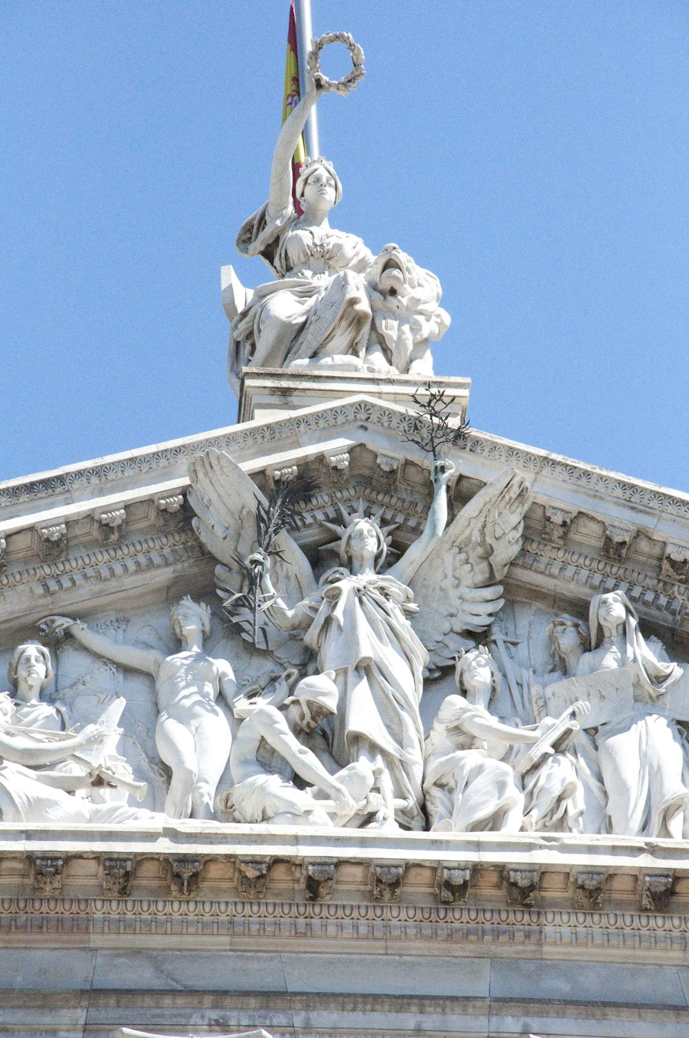 a statue of a person holding a staff and a flag