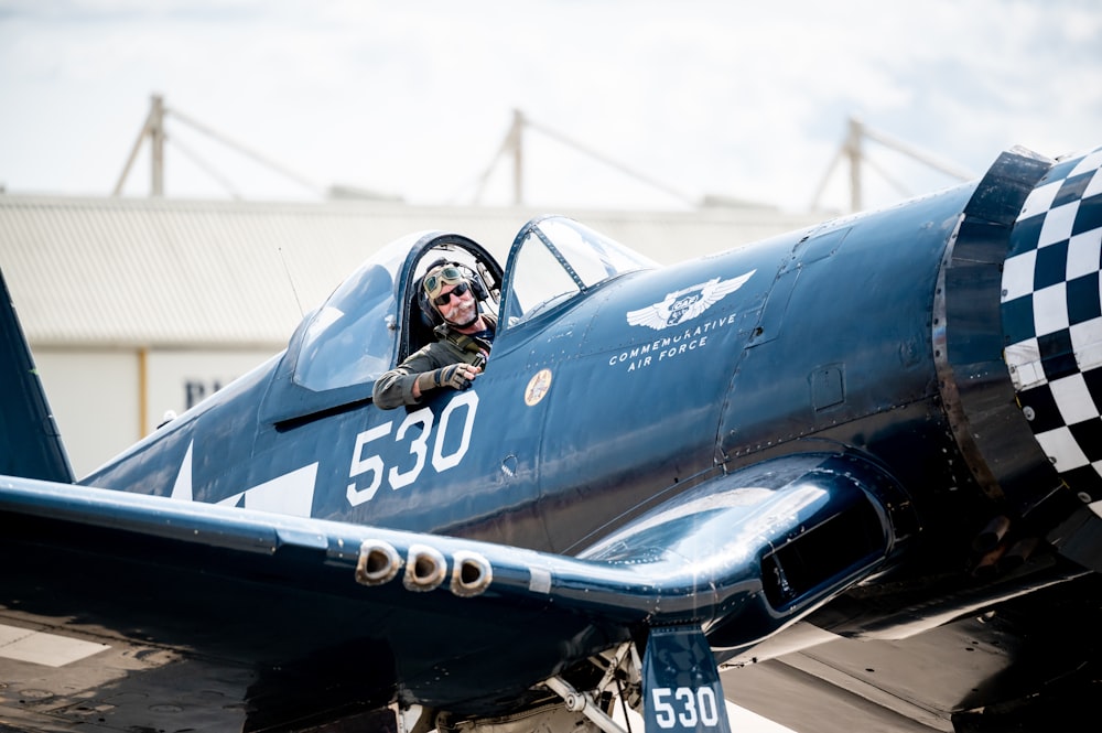 a person in a cockpit of a plane