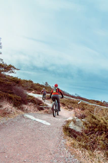 Cyclists riding through a scenic mountain trail during the Dongu Acambay pilgrimage.