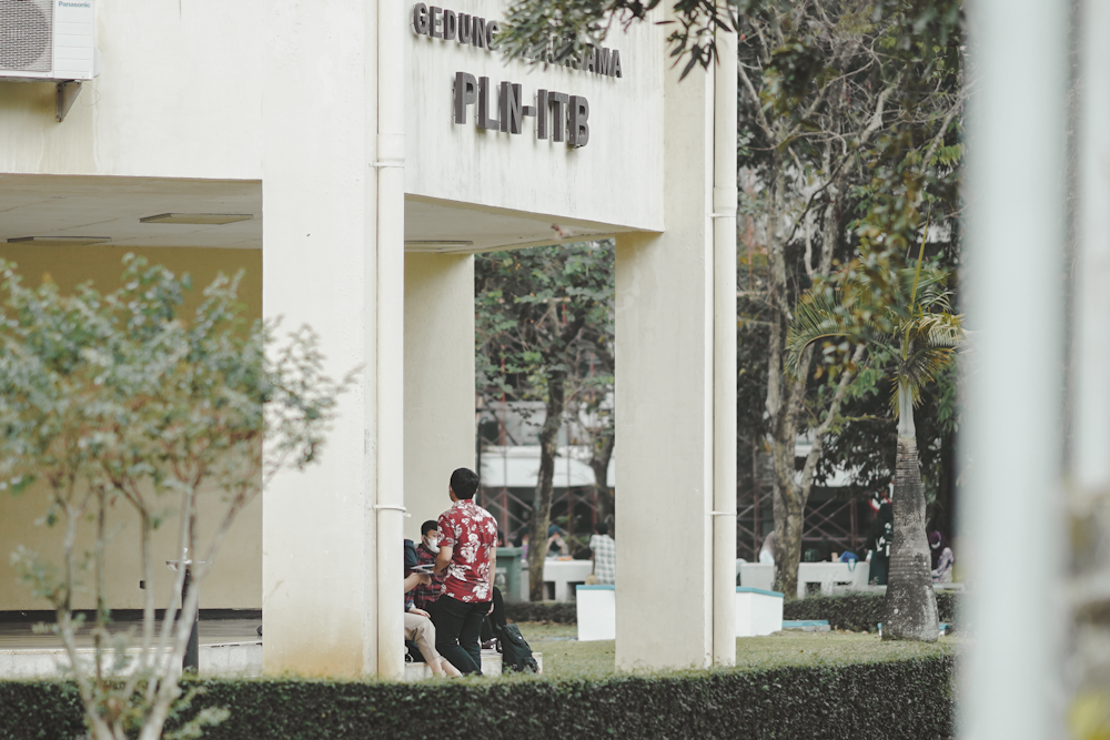 a man and a woman walking out of a building