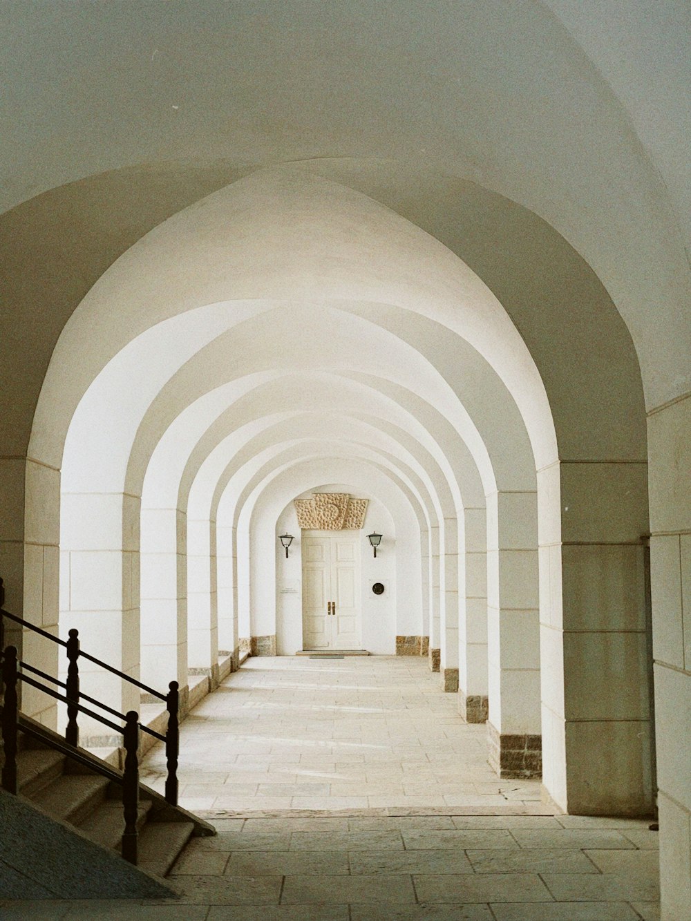 a walkway with a railing and a staircase