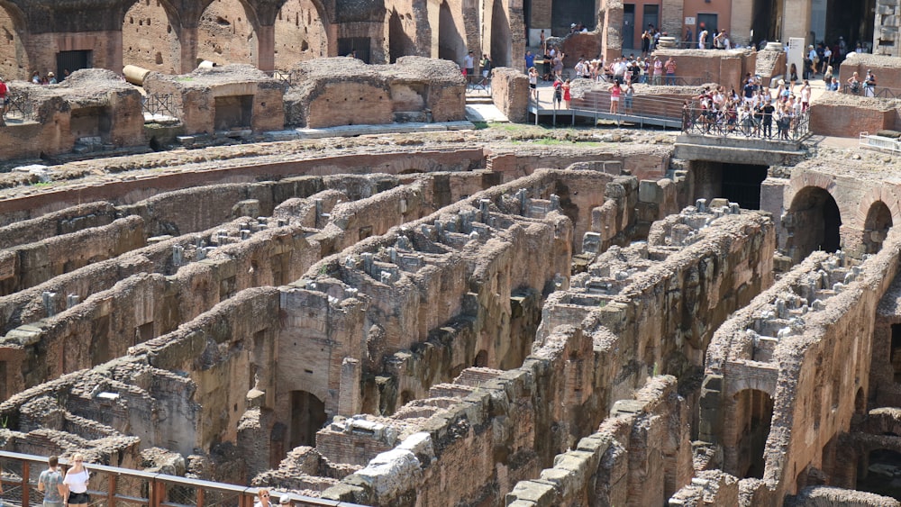 a large ancient building with people standing around it