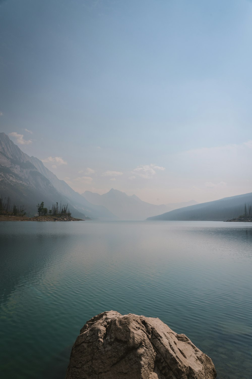 a body of water with mountains in the background