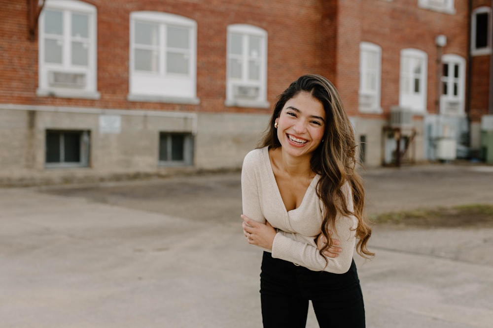 a woman smiling with her arms crossed