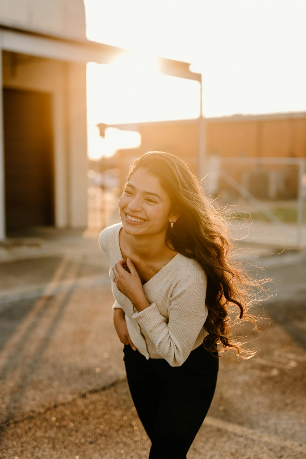 a woman smiling with her hands together