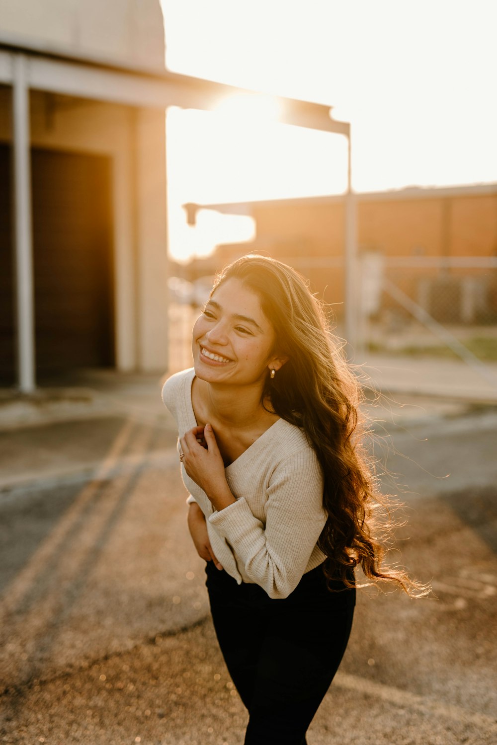 a woman smiling and hugging her belly