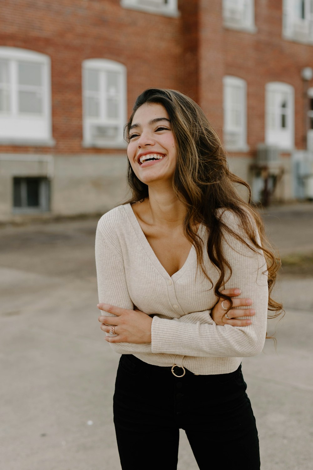 a woman smiling with her arms crossed