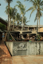 a group of people sitting on a bench in front of a building