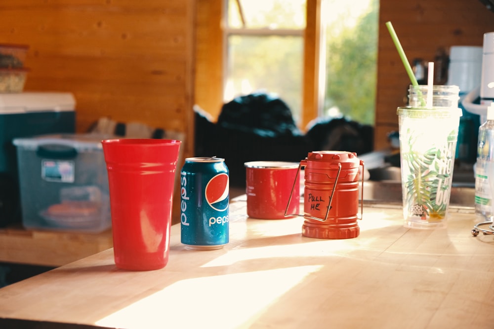 a table with cups and a glass of water on it