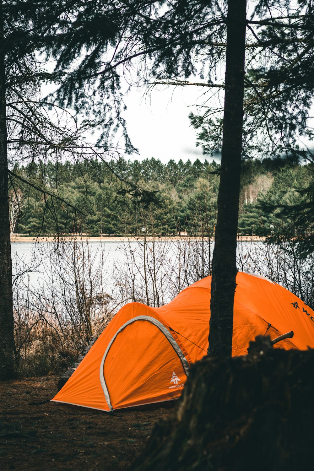 a tent on a rock by a lake