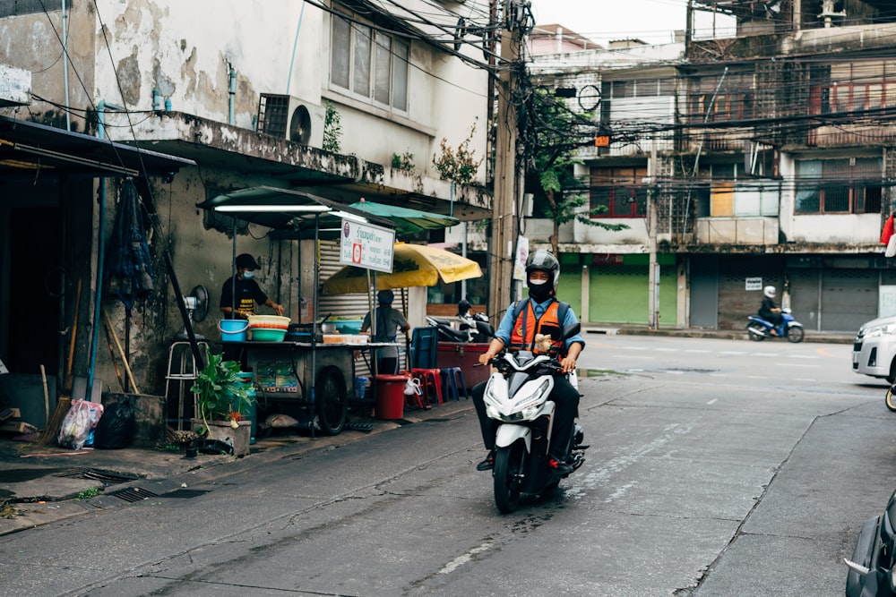 a person riding a scooter down a street