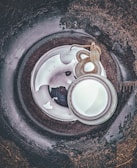 Drain snake coiled and ready beside a clean, clear drain opening