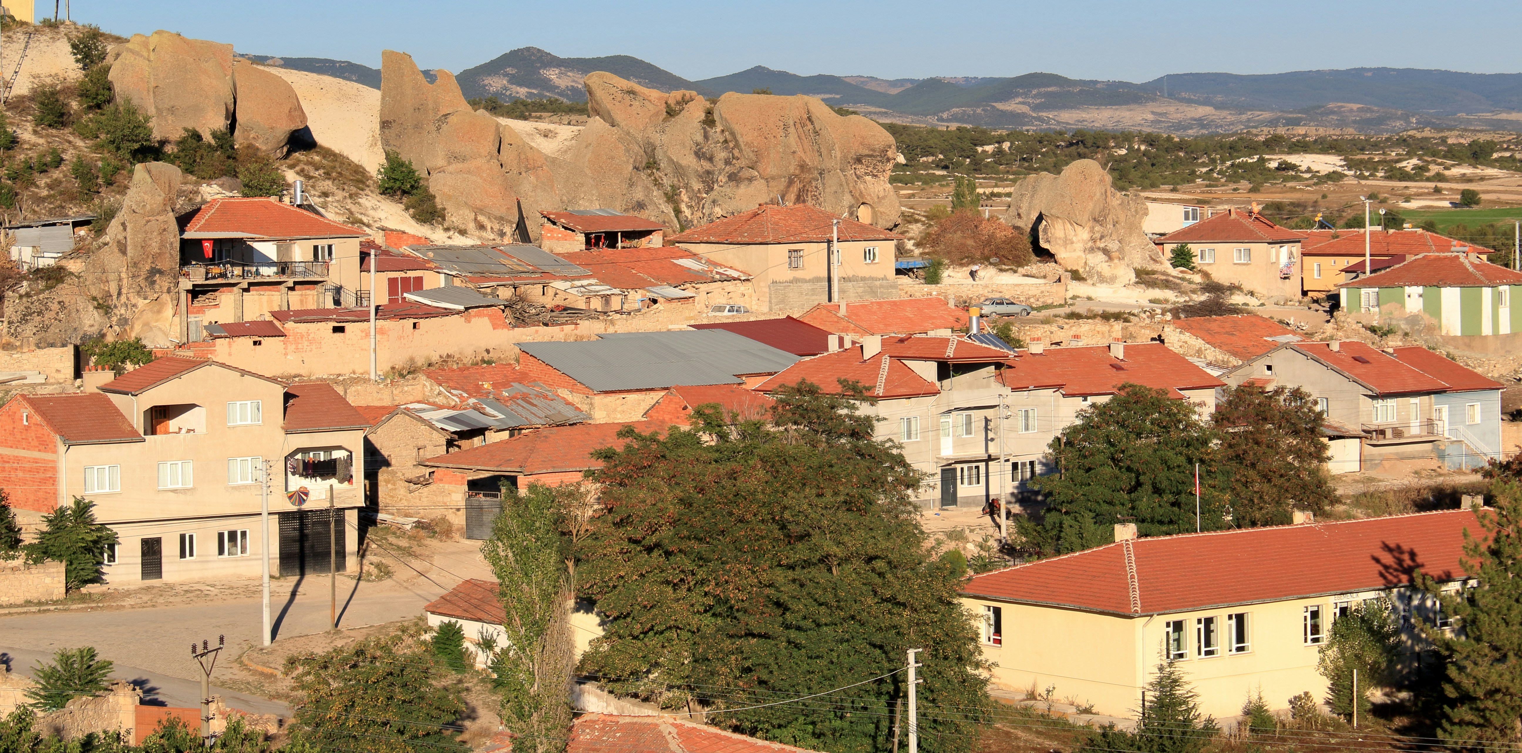 a group of buildings with mountains in the background