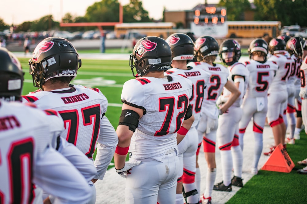 a football team walking on a field