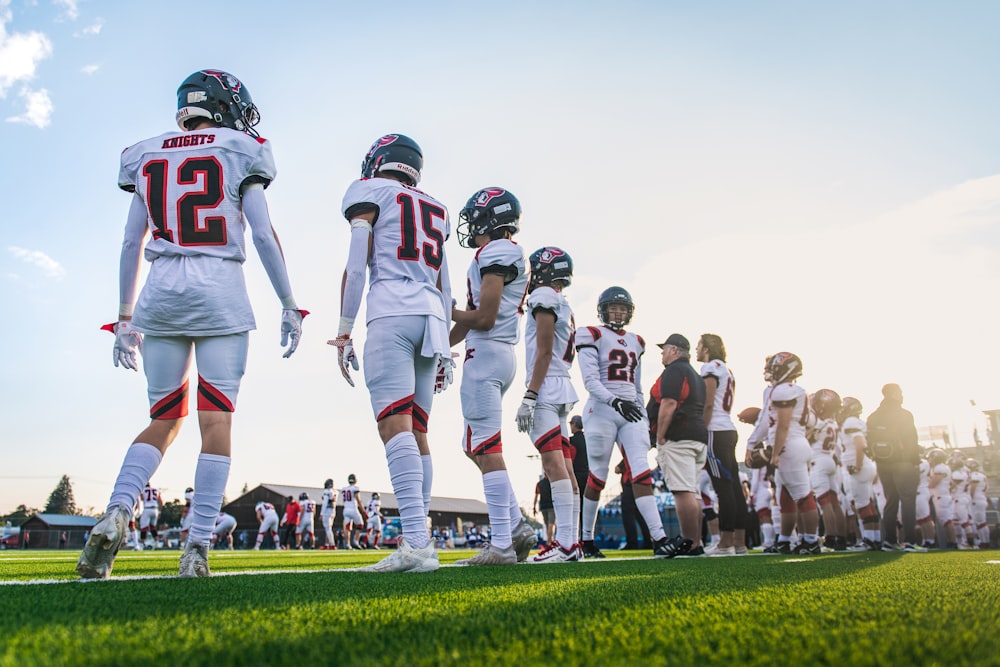 a group of football players walking on a field