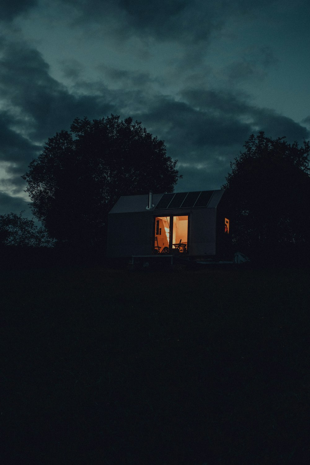 a house with a light on at night