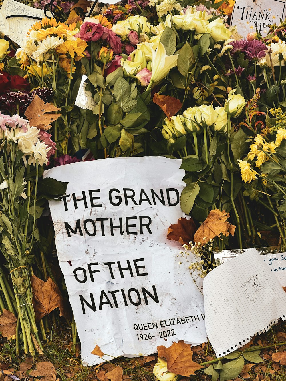 a sign in front of a bouquet of flowers