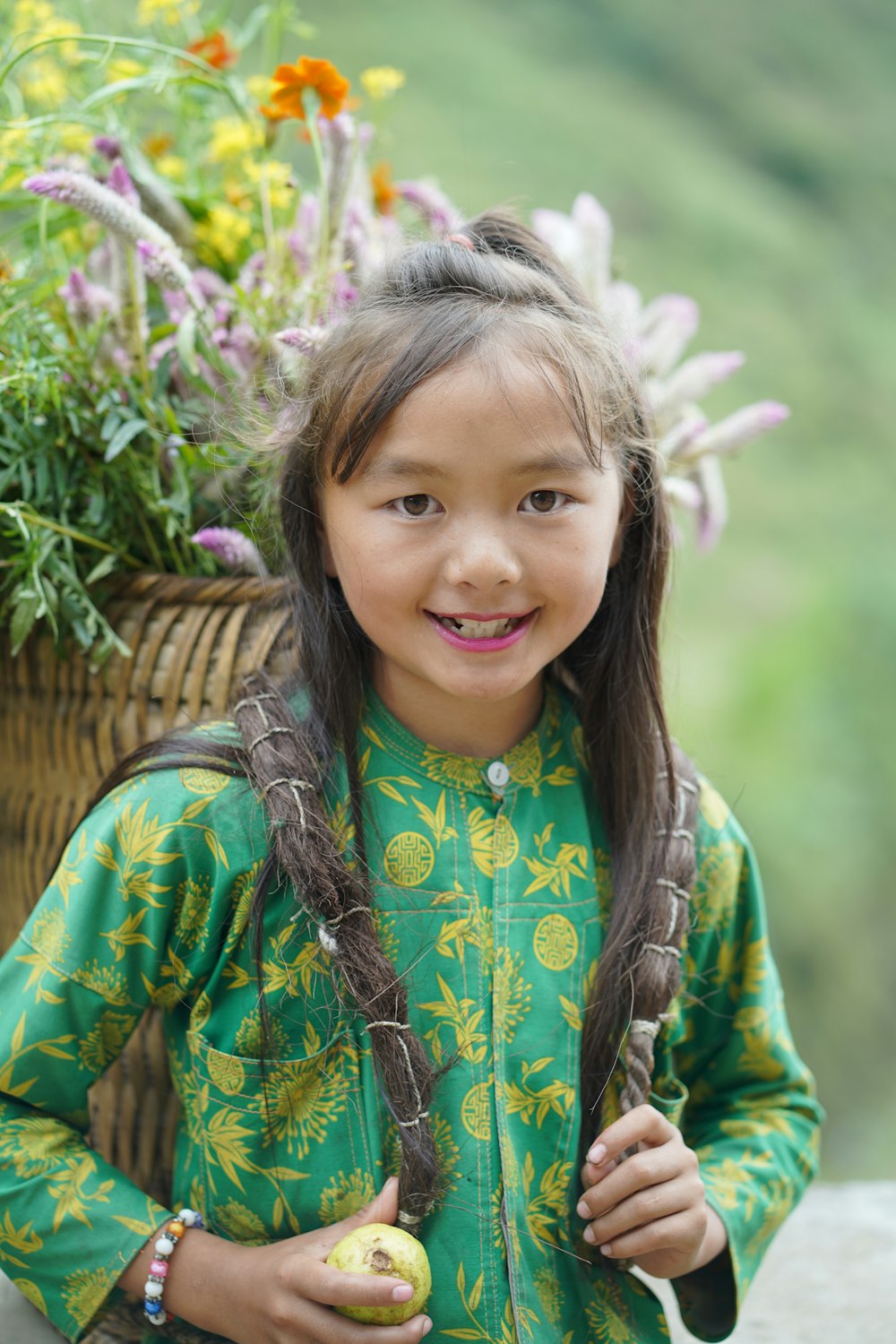 a girl holding a fruit