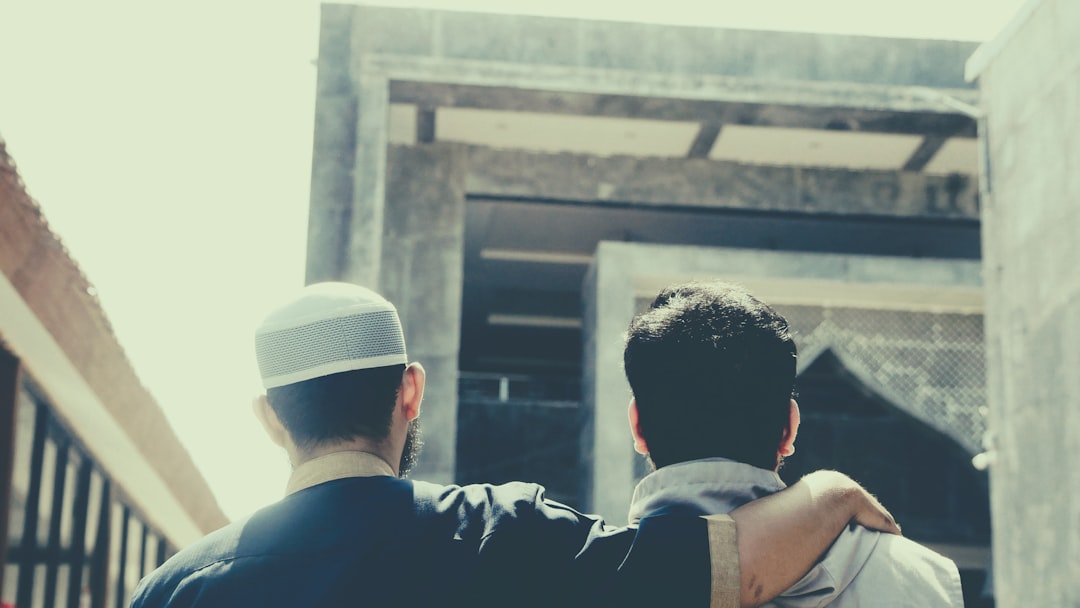 a couple of men looking at a building,