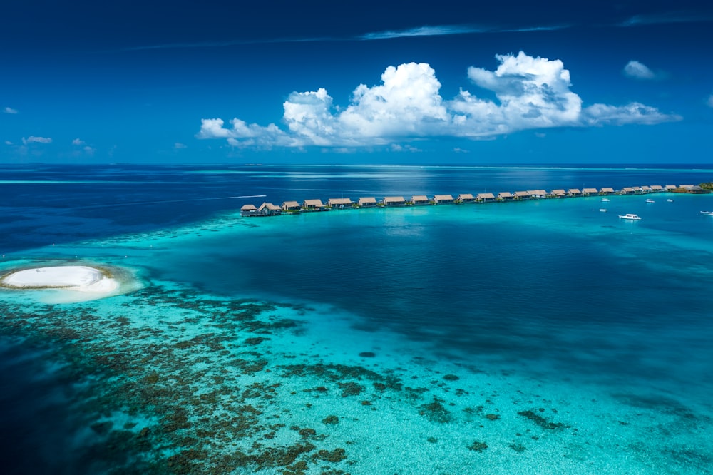 a body of water with a group of houses in the distance