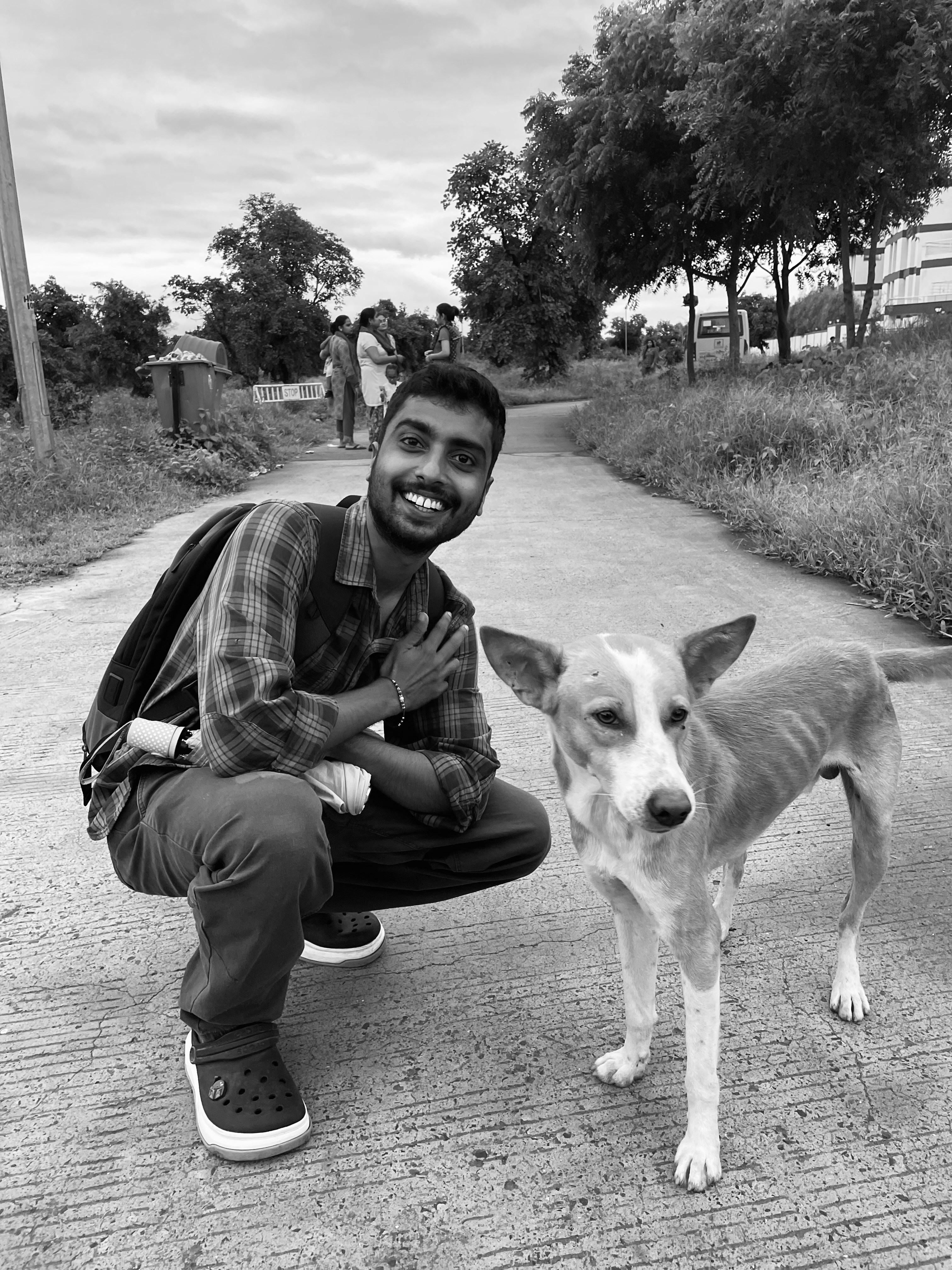 a person kneeling next to a dog