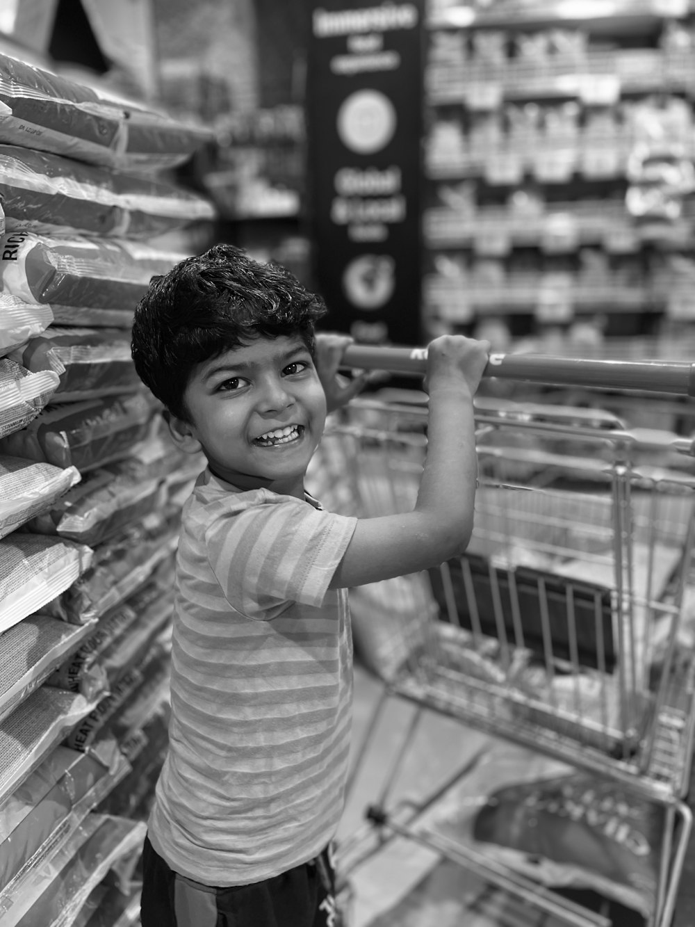 a young boy holding a barbell