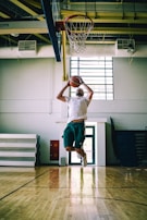 a person jumping to dunk a basketball