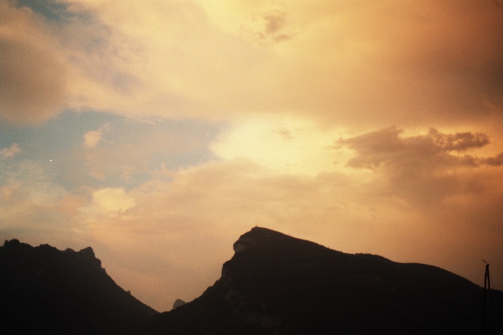 a mountain with a cloudy sky