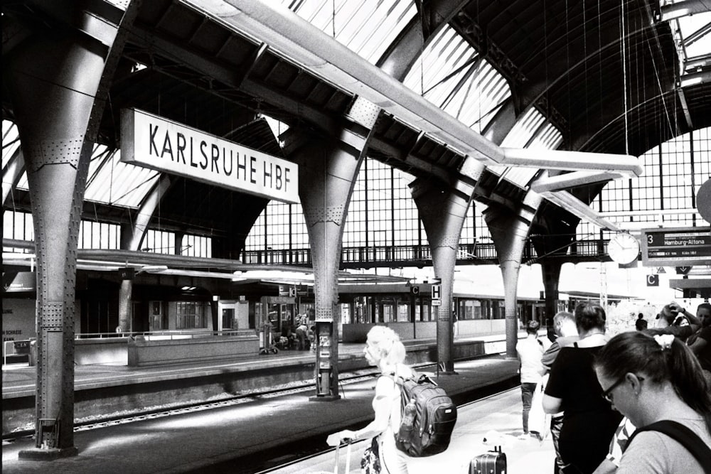 a group of people waiting for a train