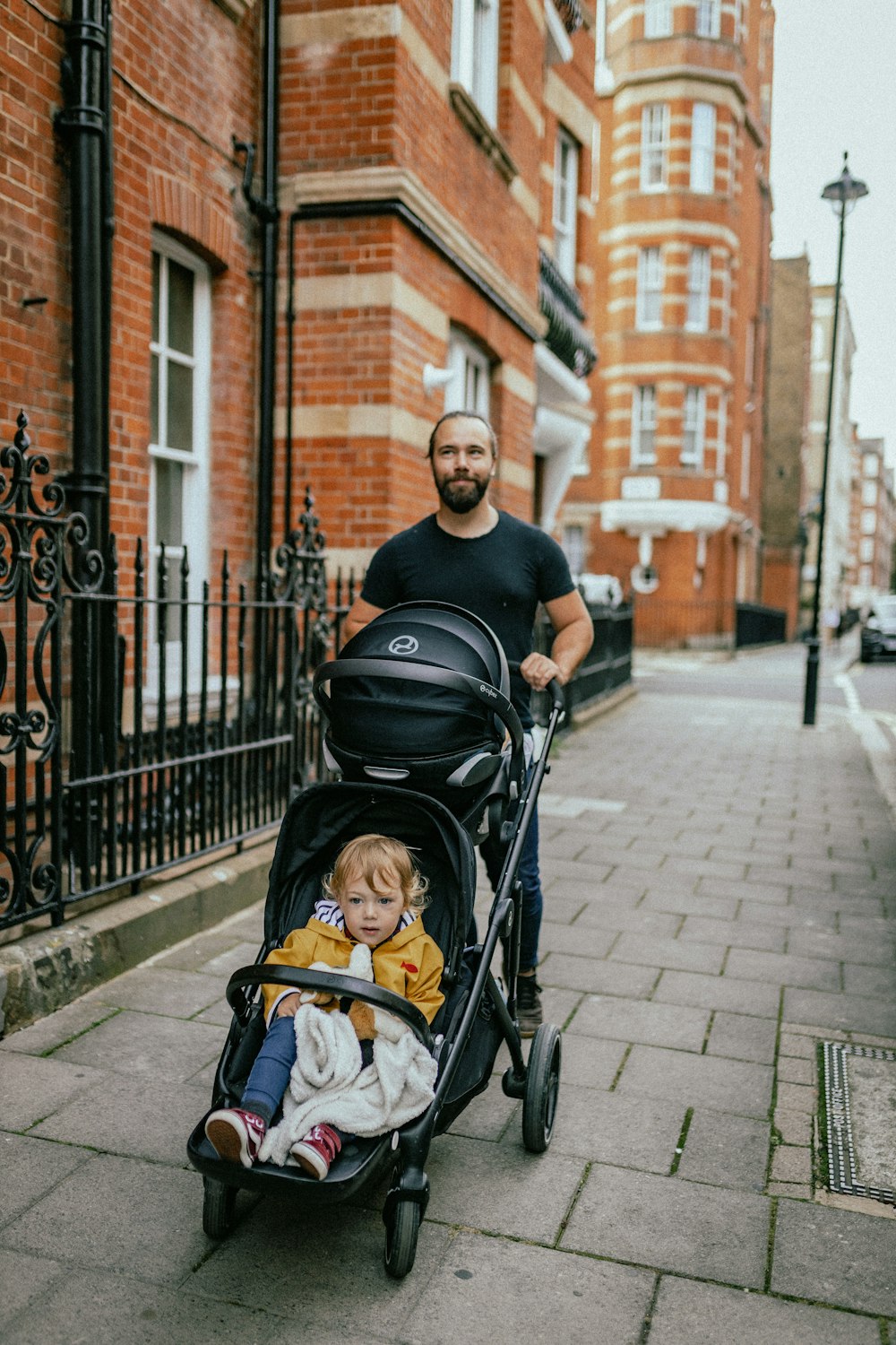 a person pushing a stroller with a baby in it