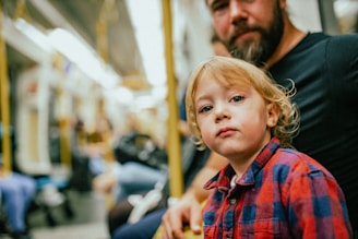 a young girl with a person in the background