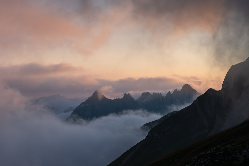 a mountain range with clouds