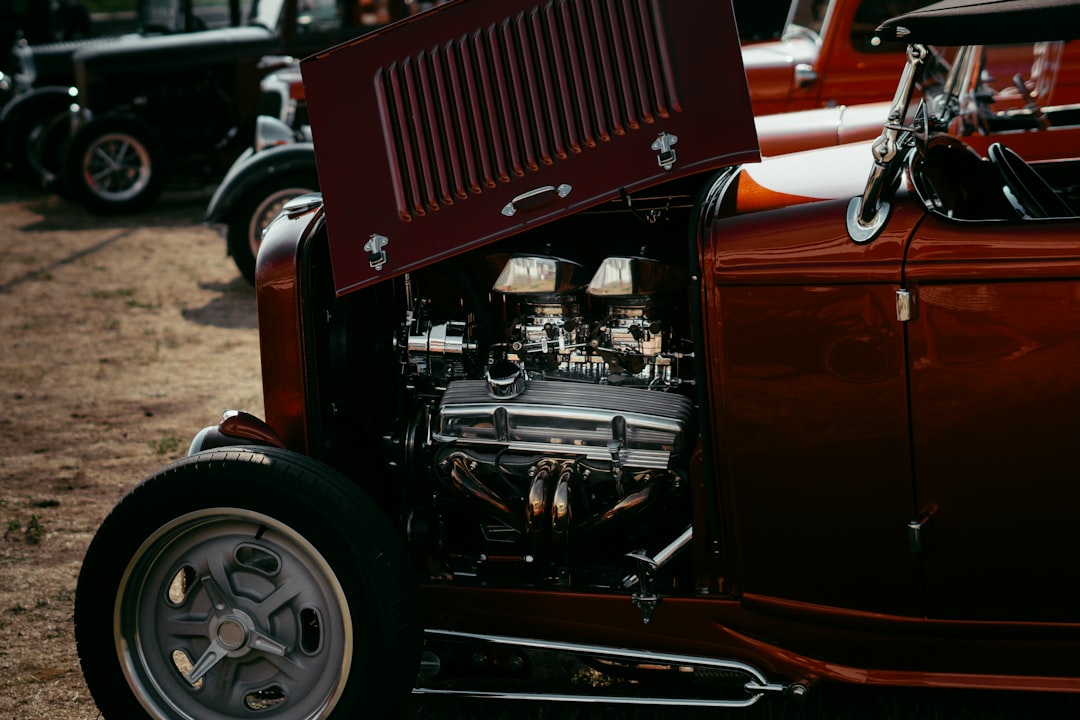 a red car with its engine exposed,