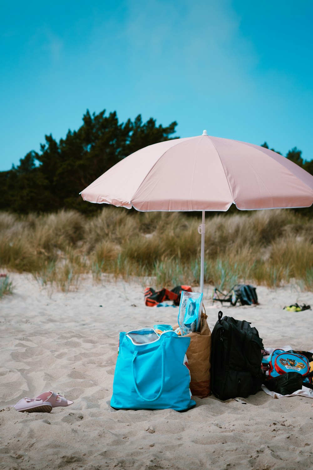 a pink umbrella on a beach