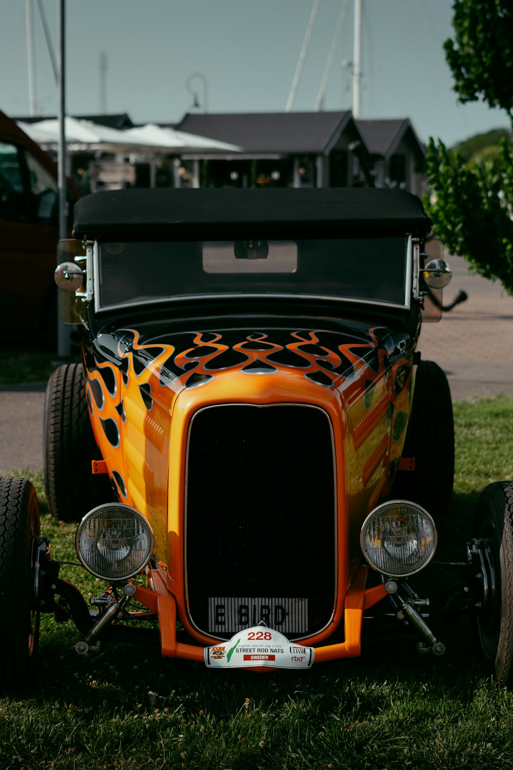 an orange car parked on grass