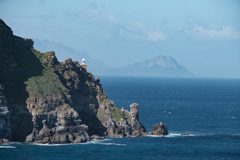 a large body of water with a mountain in the background