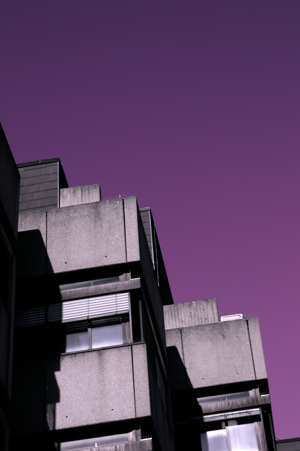 a group of buildings with a purple sky
