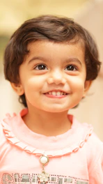a close-up of a girl smiling