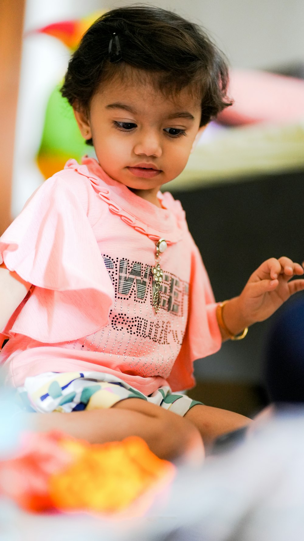 a young girl holding a baby